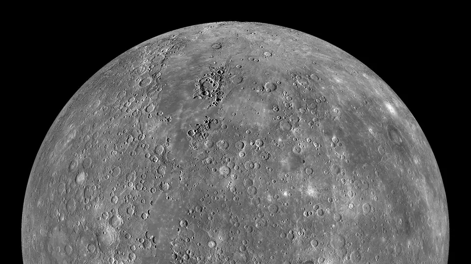 The grey, cratered planet Mercury against black space, photographed by NASA's MESSENGER spacecraft.